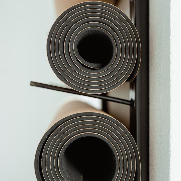 A calm and clean studio interior with yoga mats ready for a class.